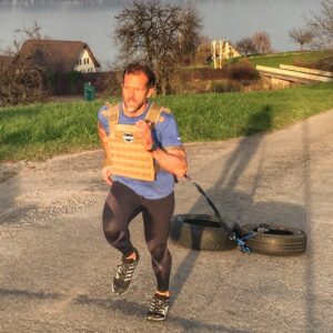 Jeff Grant running with weight vest and dragging tires